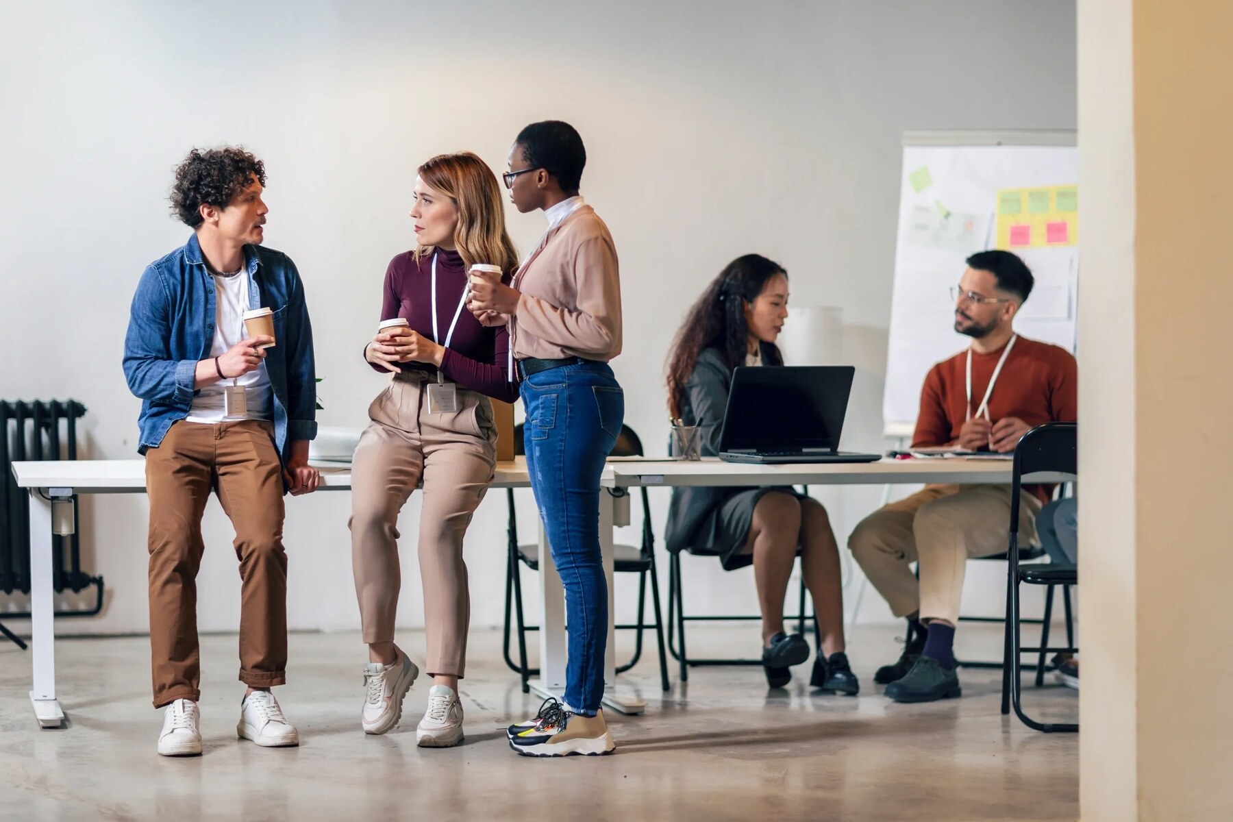 Colleagues with coffee in a modern office
